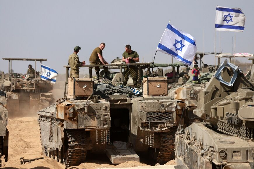 Israeli soldiers atop a tank near the border with the Gaza Strip on May 2, 2024