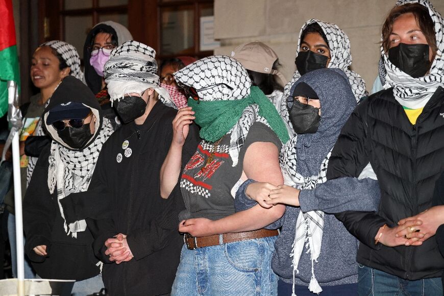 Pro-Palestinian student protesters lock arms on the campus of Columbia University in New York City on April 30, 2024