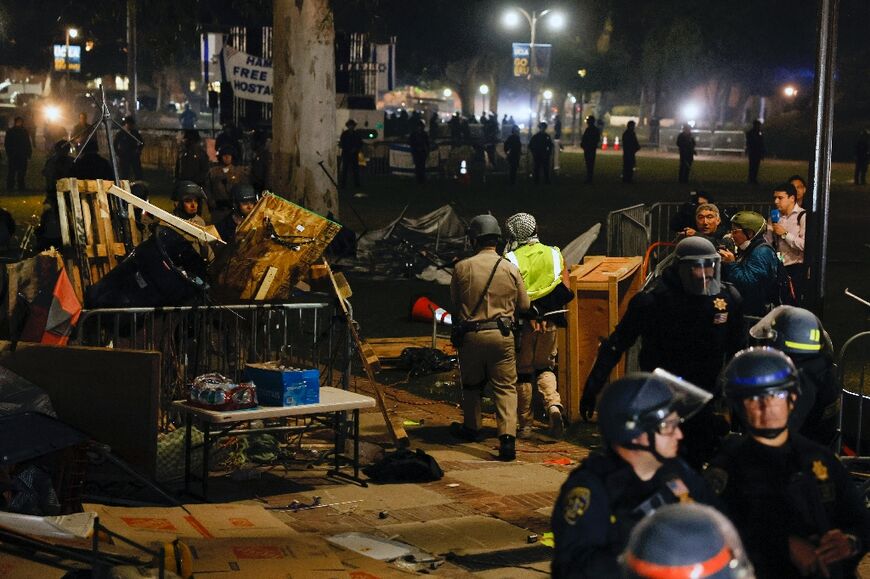 Tents and barricades were dismantled and protesters led away from the University of California, Los Angeles in an all-night operation