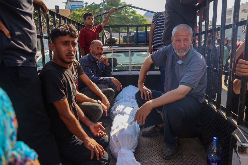 Relatives transport the body of a person killed in the Israeli strike on the UN school housing displaced Palestinians in Nuseirat