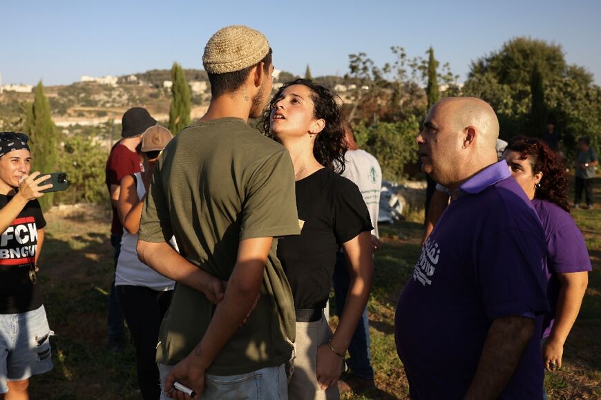 Standoff: activists confront settlers they say 'took advantage of the war' in Gaza