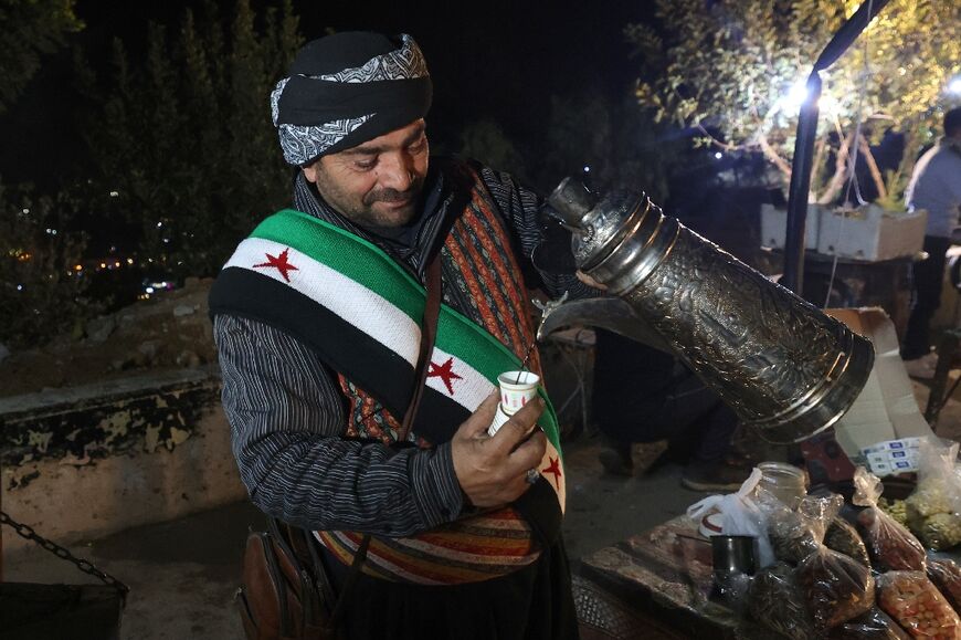 A man sells tea on Mount Qasyun, from which government artillery used to pound rebel-held areas under Assad's rule