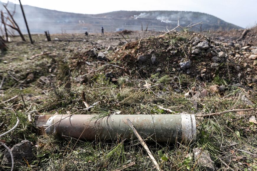 In the aftermath of a reported Israeli air strike on a Syrian weapons bunker, shrapnel and damaged weapons littered the hillsides around