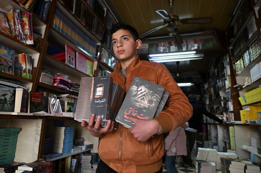 A staff member carries novels that were reportedly banned