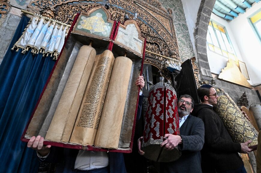 Rabbis from the United States hold Torah scrolls during a visit to the Ifrange synagogue in Damascus.