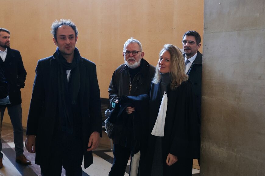 French photojournalist Edouard Elias (left) and French journalist Didier Francois (centre), also former hostages, were in court