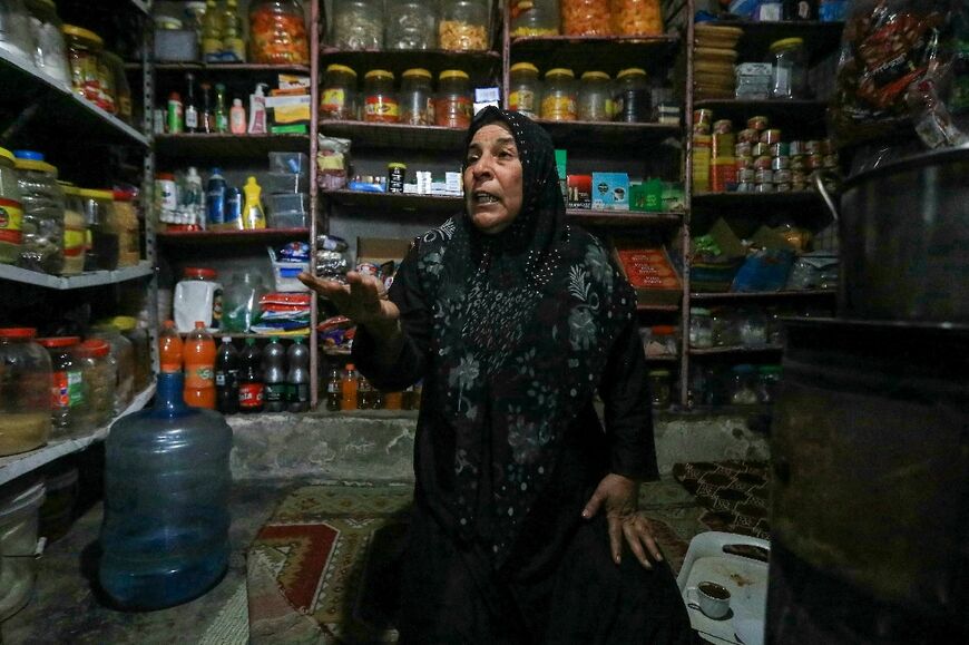 Shelves of foodstuffs line the walls of a shop in the Atme camp
