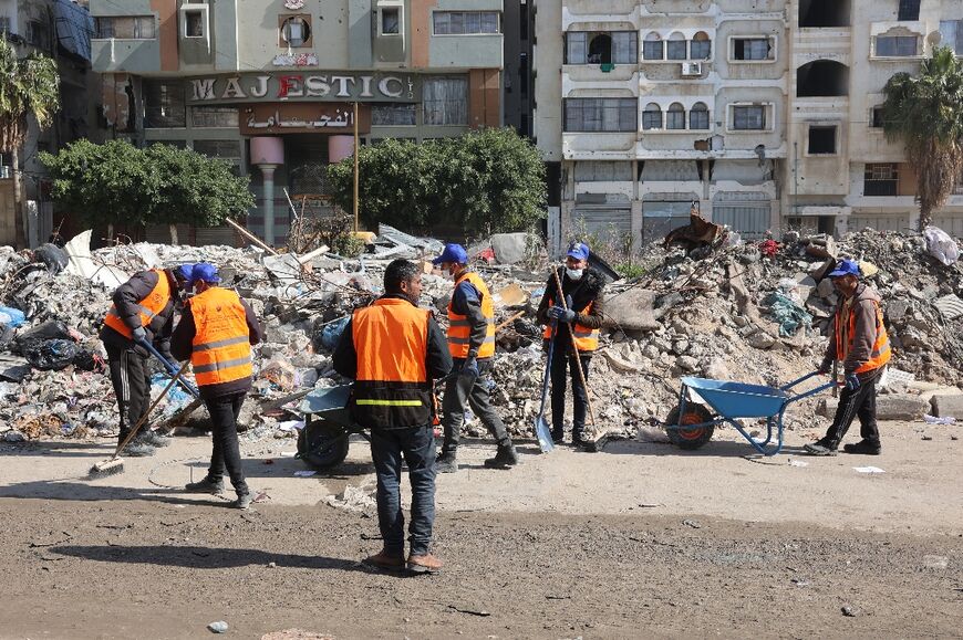Workers in Gaza City clean rubbish from a road in preparation for the Muslim holy month of Ramadan, as the first phase of a Hamas-Israel truce is set to expire