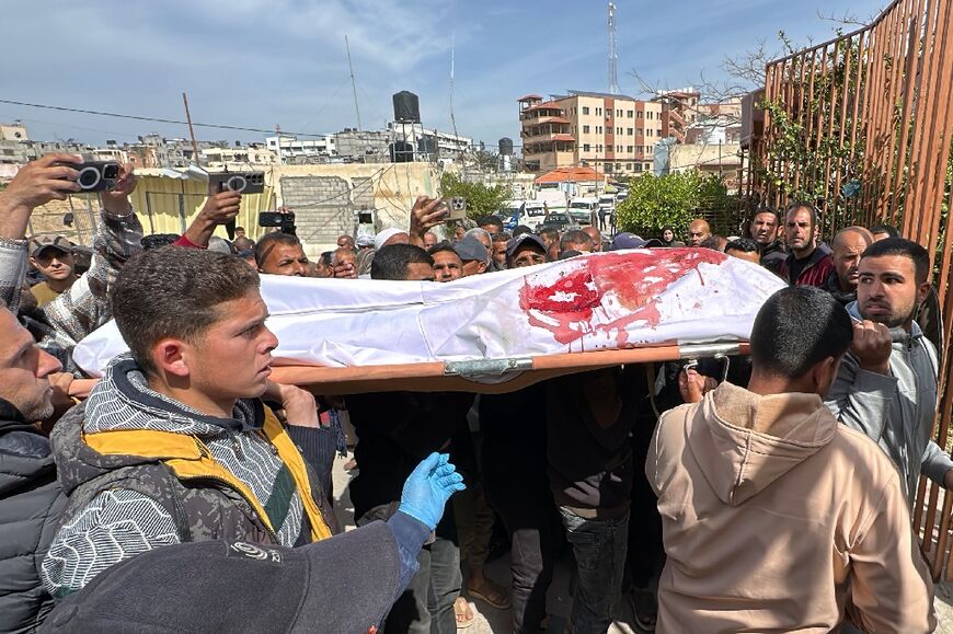 People in southern Gaza carry the body of a man killed by the Israeli army, which said it had opened fire on two suspects who posed a threat