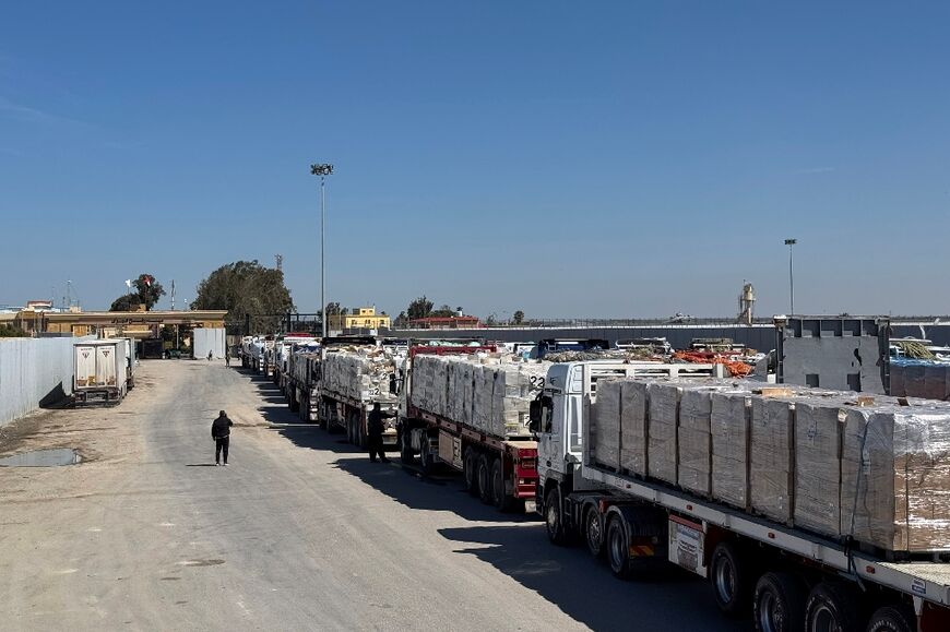 Trucks carrying humanitarian aid line up on the Egyptian side of the Rafah border crossing with Gaza after Israel suspended the entry of supplies 
