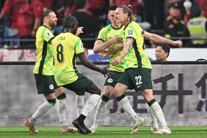 Australia's Jackson Irvine (right) celebrates with teammates after scoring against China in Hangzhou