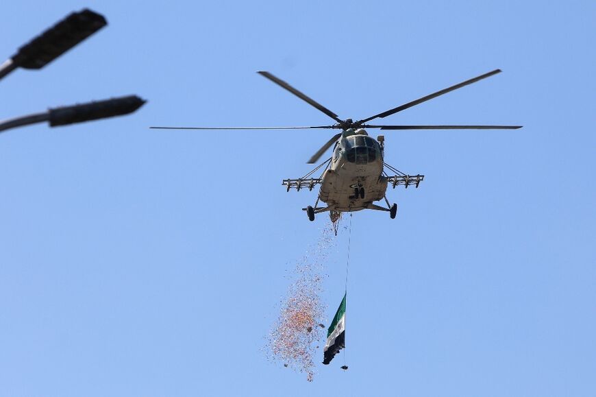 Helicopters flew the Syrian flag and dropped leaflets calling for unity 