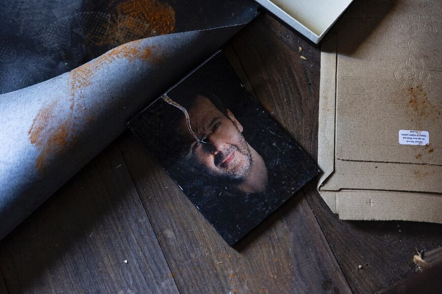 A torn photo of Maher al-Assad, the brother of ousted Syrian president Bashar al-Assad, in his looted villa