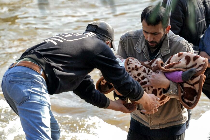 Alawites fleeing across a river from Syria into northern Lebanon 