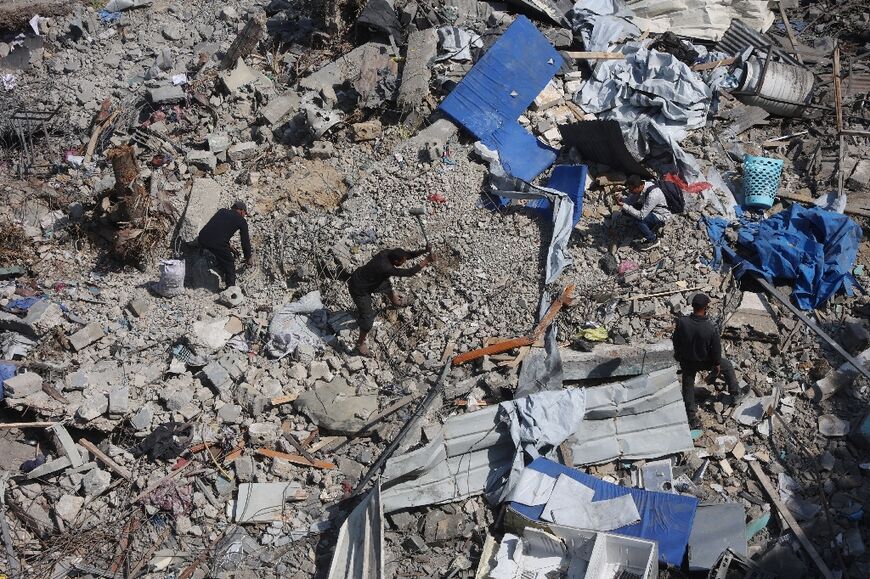Some scoured through the rubble of buildings destroyed in the strikes in the search of casualties