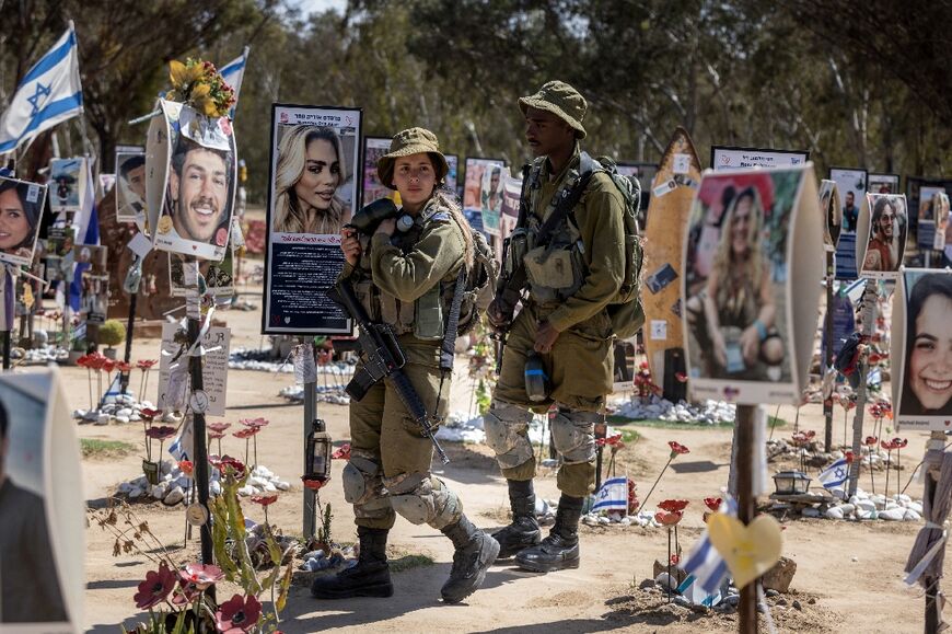 Israeli soldiers patrol at a memorial for the victims at the site of the Nova music festival attack that took place on October 7, 2023
