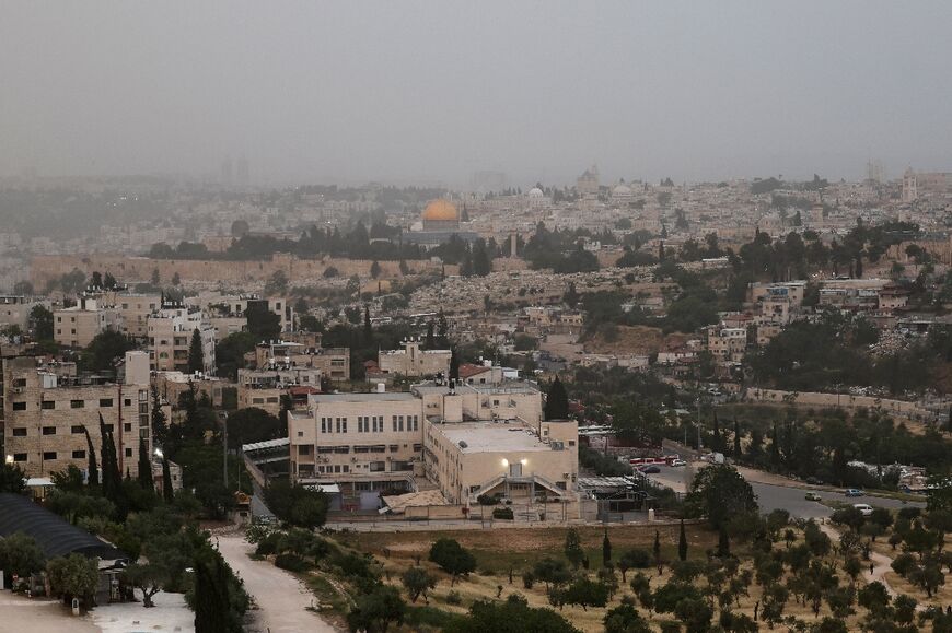 Jerusalem seen as a cloud of smoke rises from a large forest fire on the outskirts of the city