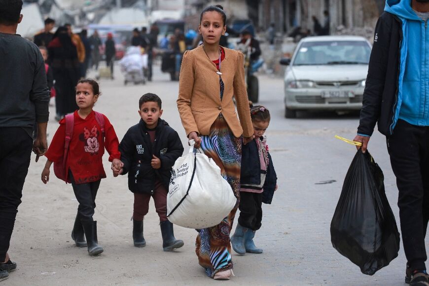 Palestinians arrive in Gaza City after fleeing areas to the east following Israeli evacuation orders