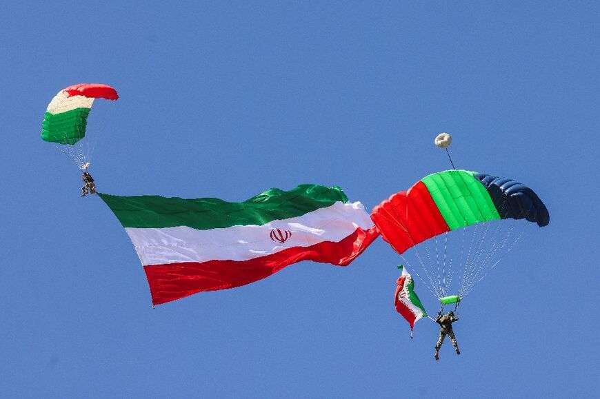 Paratroopers also took part, flying the Iranian national flag