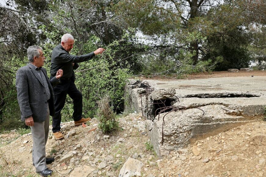 In the town of Souk al-Gharb, overlooking Beirut, former fighters from different backgrounds walk through grass covering the old front line to an abandoned bunker
