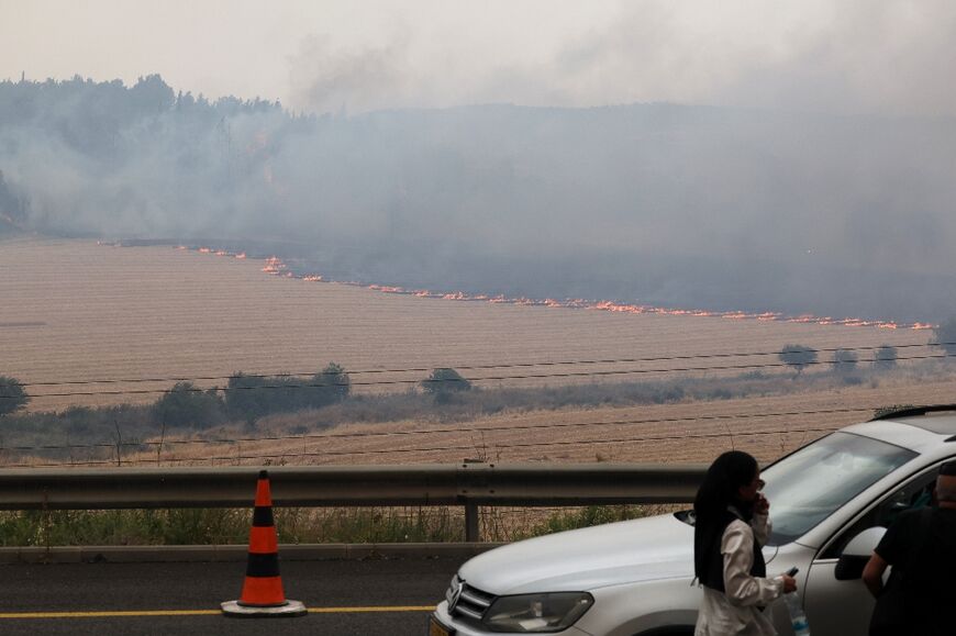 Flames engulf vegetation during a forest fire along a highway near Bet Shemesh