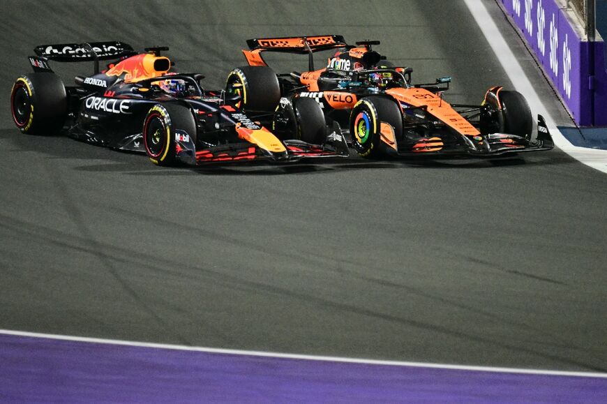 Red Bull's Max Verstappen (L) was given a 5-second penalty for leaving the track and gaining an advantage over McLaren's Oscar Piastri (R)