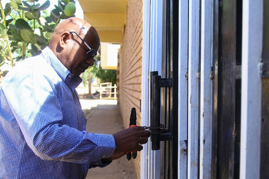 AFP journalist Abdelmoneim Abu Idris Ali at the door of his home in Khartoum North