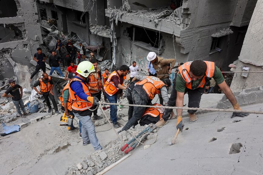 Palestinian rescuers at the site of Wednesday's deadly Israeli strike in Gaza City
