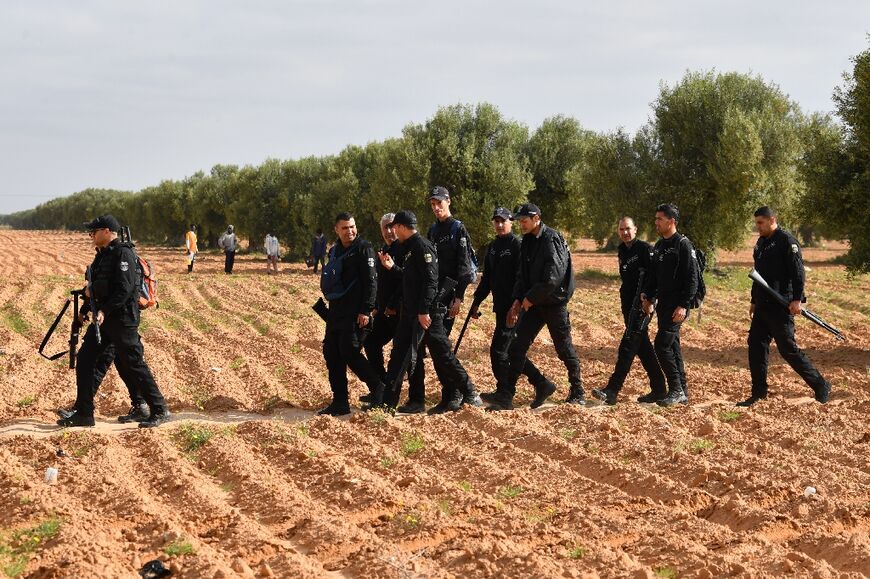 Tunisian police pictured during the operation to clear the migrants' camp