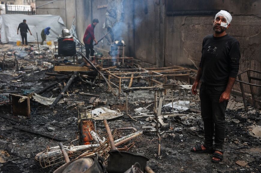 Palestinians inspect the damage after an Israeli strike on the Yafa school building, a school-turned-shelter