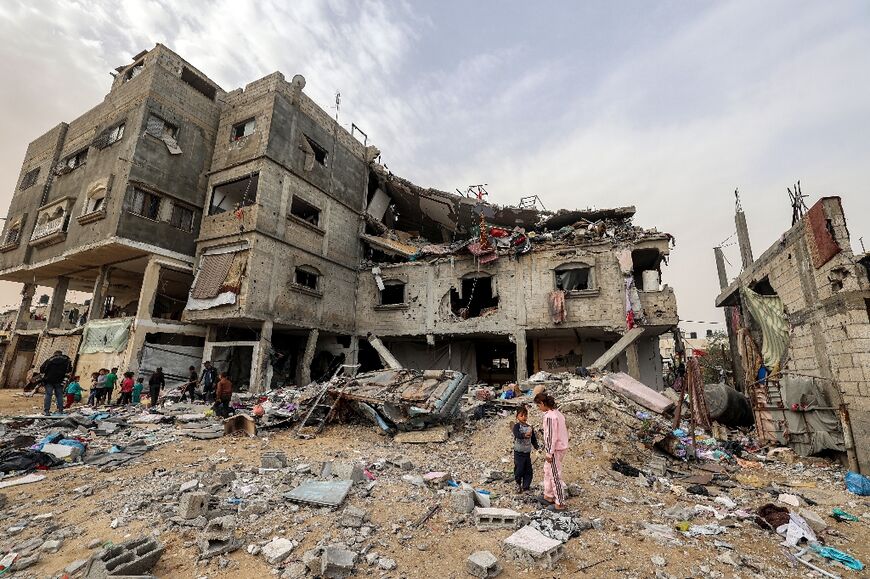 A plastic chair, blankets and a bright red children's bath tub were trapped between two collapsed floors of a house