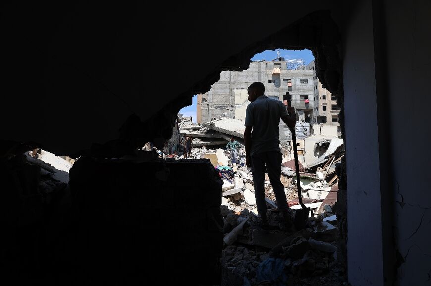 A Palestinian inspects the damage following overnight Israeli strikes at the Nuseirat refugee camp in the central Gaza Strip
