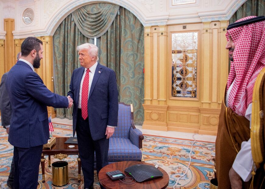 Saudi Crown Prince Mohammed bin Salman watches as US President Donald Trump (C) shakes hands with Syria's interim president Ahmed al-Sharaa in Riyadh