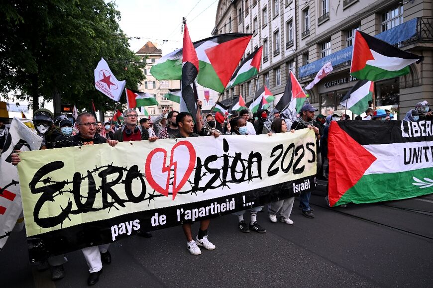 Activists held Palestinian flags and a banner during a demonstration against Israel's participation in the Eurovision Song Contest final