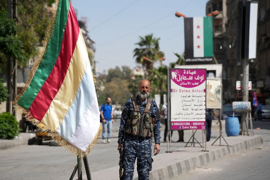 A member of the Druze security forces stands guard in Jaramana earlier this week