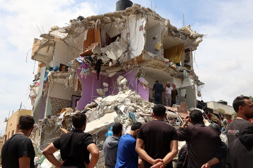 Neighbours inspect the damage to a house in the West Bank vilage of Tammun where Israeli troops killed five suspects in a raid.