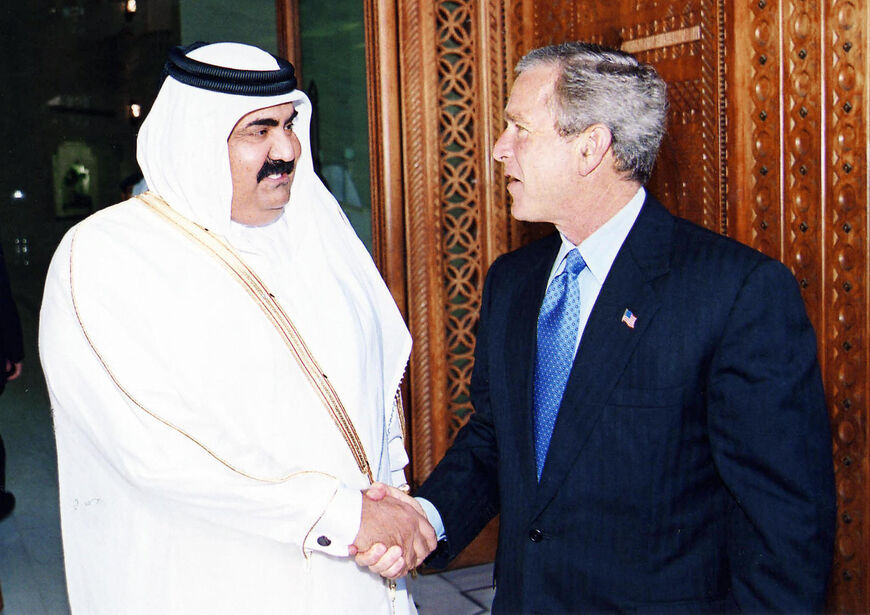 US President George W. Bush (R) is greeted by the emir of Qatar Sheikh Hamad bin Khalifa al-Thani in Doha 05 June 2003. Bush defiantly vowed to find Saddam Hussein's weapons of mass destruction in a speech at a US military base in Qatar earlier in the day, ignoring the heated debate about the failure so far to turn up firm evidence that Saddam possessed the weapons which sparked the war. AFP PHOTO/Khaled MOUFTAH (Photo credit should read KHALED MOUFTAH/AFP via Getty Images)