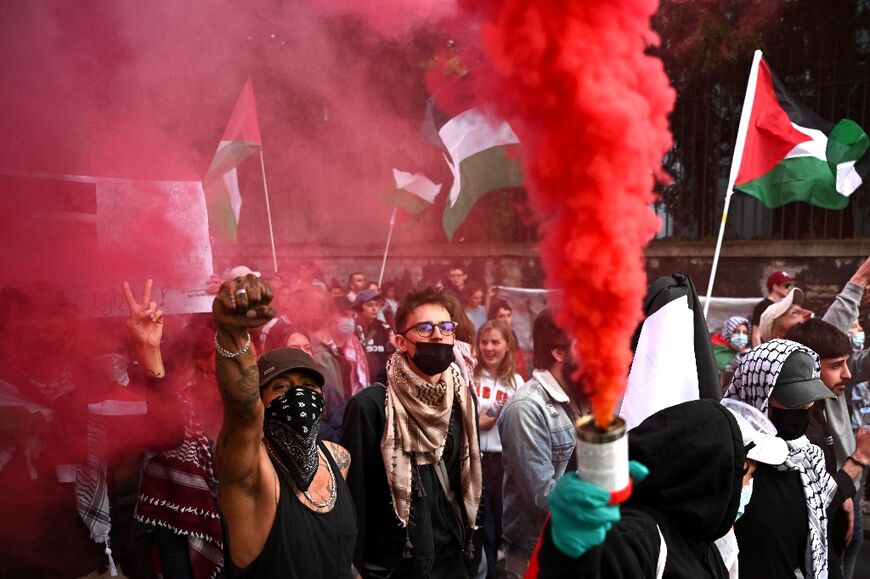 Protesters hold a smoke bomb and Palestinian flags during a demonstration against Israel's participation in the Eurovision Song Contest in Basel