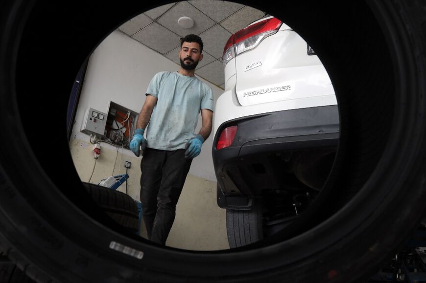 Mohammed Ismail working at his car repair shop in Arbil