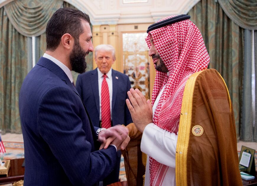 A handout picture provided by the Saudi Royal Palace shows Saudi Crown Prince Mohammed bin Salman greeting Syria's interim President Ahmed al-Sharaa as US President Donald Trump looks on in Riyadh
