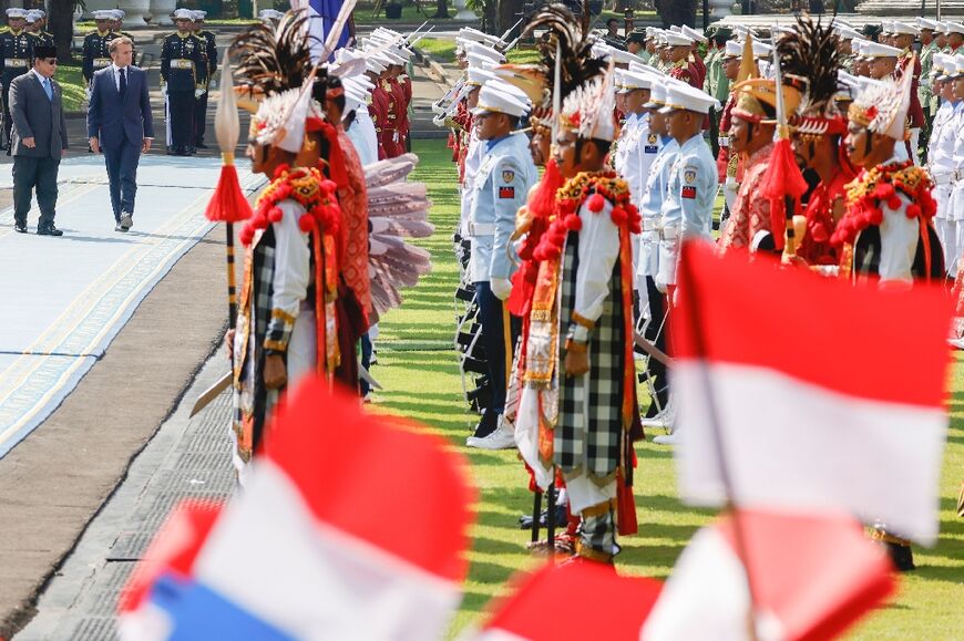 Macron was met by a guard of honour at the presidential palace in capital Jakarta
