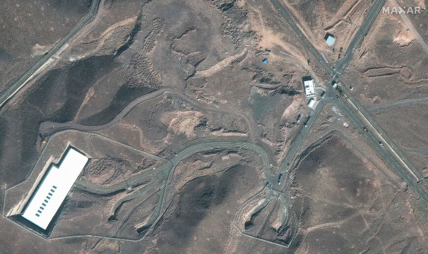 This handout satellite image courtesy of Maxar Technologies shows cargo trucks postioned near an underground entrance to Iran's Fordow Fuel Enrichment Plant (FFEP), in Fordo, Iran on June 20, 2025