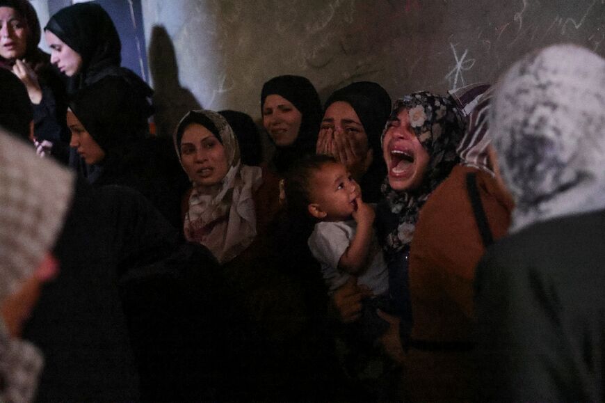 Palestinians mourn members of a family killed in Israeli strikes on their home in the north of the Gaza Strip on May 29