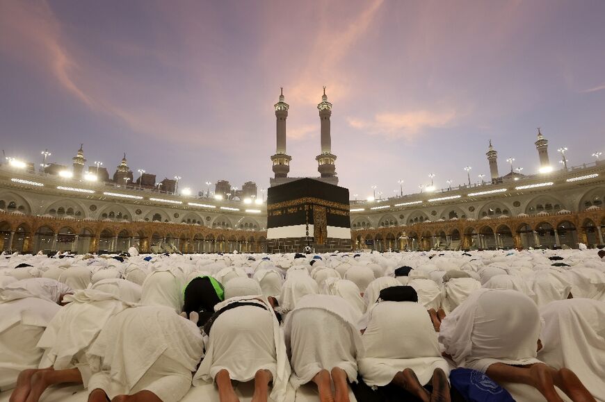 Muslim worshippers pray around the Kaaba, Islam's holiest shrine, at the Grand Mosque complex in the Saudi city of Mecca