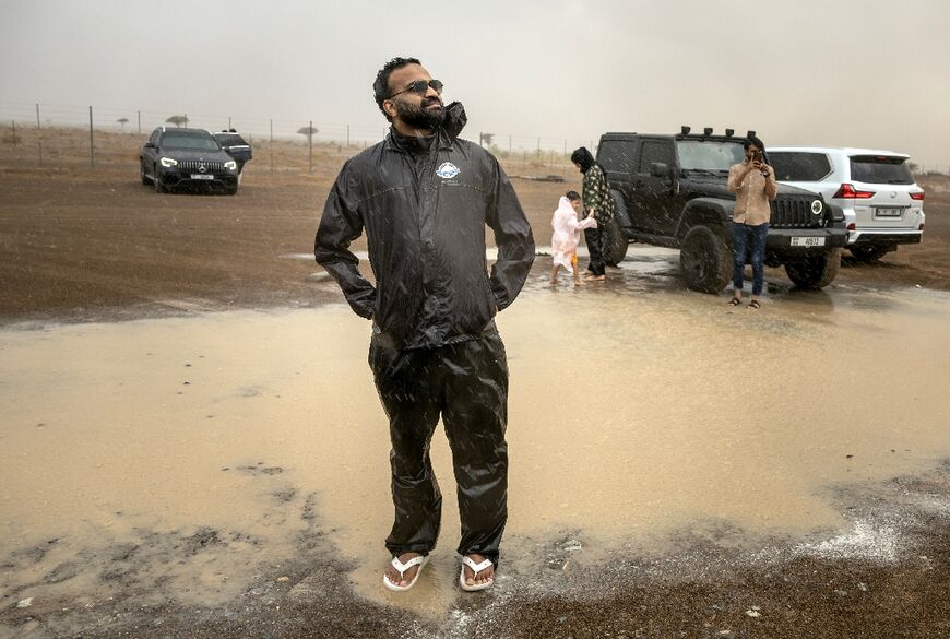 "Amazing moment". Sajjad, whose amateur meteorological skills have earnt him the moniker of "The Weatherman", stands proudly in a large puddle formed by adesert shower.