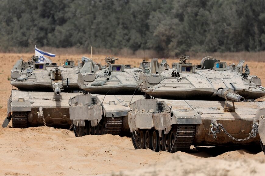 Israeli troops deploy at the border with the Gaza Strip on Tuesday, as the military announced it had expanded its campaign in the territory