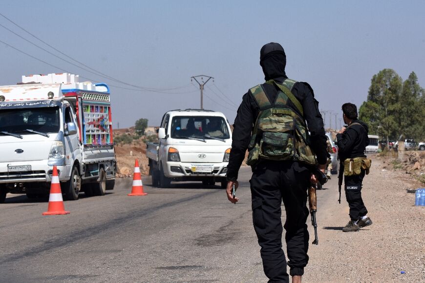 Syrian security forces man a checkpoint to prevent fighters from other parts of the country joining the fighting in Sweida after the government ordered an immediate ceasefire.