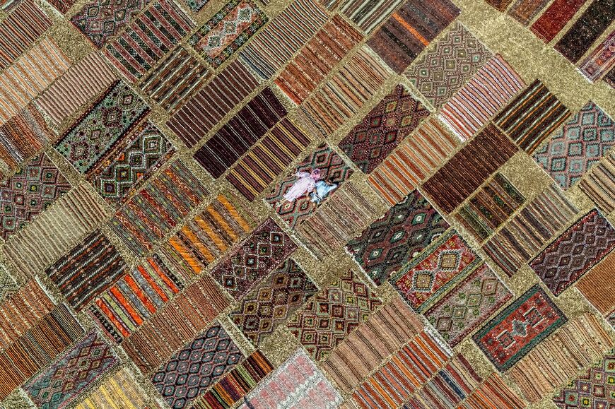 Around 50 workers watch the carpets day and night, turning them regularly and monitoring the weather -- dozens of local people rush to help fold them in the event of rain