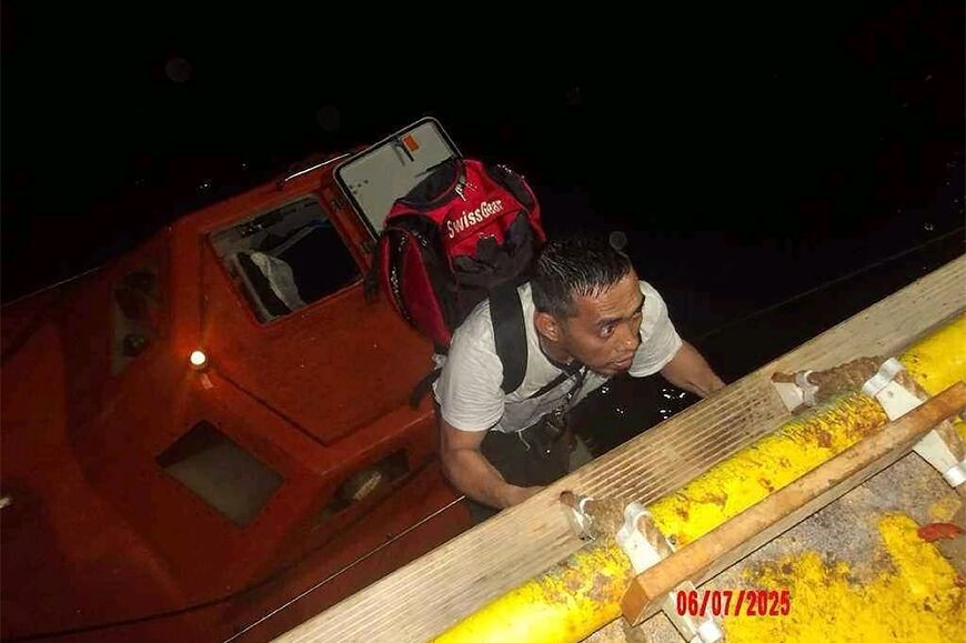 A handout picture from the UAE showing the crew of the Magic Seas being rescued by an Emirati ship