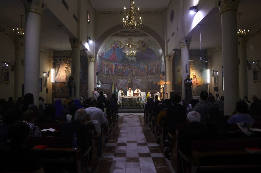Members of the clergy hold mass for late Pope Francis at the Holy Family Church in Gaza City on April 21, 2025